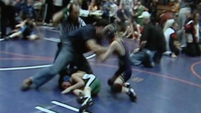 VIDEO:  2007: Man thinks son is getting hurt, tosses 10-year-old opponent out of match.