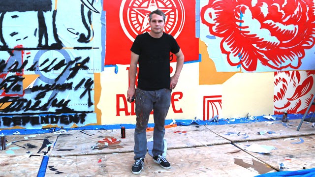 Graphic artist Shepard Fairey stands infront of his new mural going up in Wynwood Walls in Miami before the start of Art Basel Miami Beach.