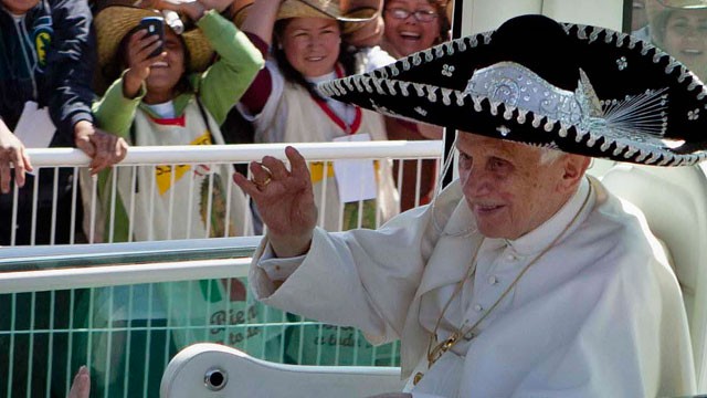 In this Sunday, March 25, 2012 file photo, Pope Benedict XVI waves from the popemobile wearing a Mexican sombrero as he arrives to give a Mass in Bicentennial Park near Silao, Mexico.