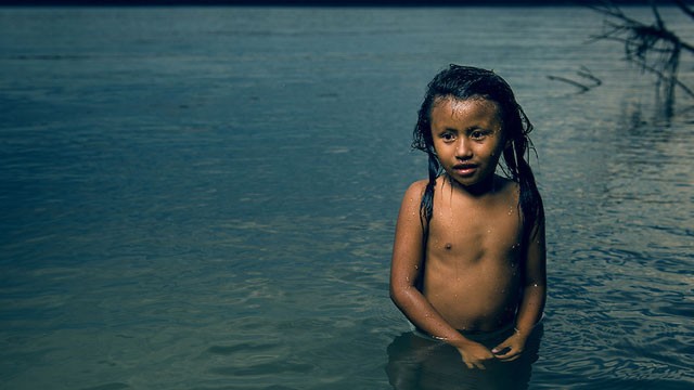 A still from the short documentary "Yasuni" directed by Nicolas Entel. An indigenous girl bathes in the Napo River, the gateway to the Yasuni National Park in Ecuador, which is endangered by oil expolitation.
