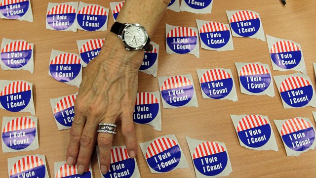 PHOTO:&nbsp;An election judge arranges "I Vote, I Count" stickers on a table in the Marion County Clerks office as voterscast early ballots in Indianapolis, Monday, Oct. 22, 2012.