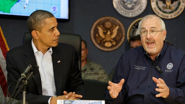 PHOTO: President Barack Obama, left, listens as Federal Emergency Management Agency administrator Craig Fugate speaks to the media at FEMA Headquarters in Washington, on Sunday, Oct. 28, 2012.