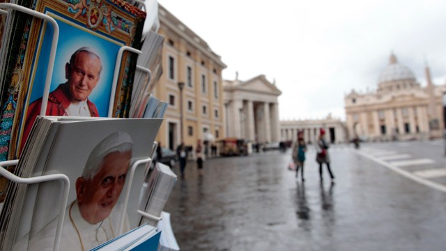 PHOTO: Postcards of Pope Benedict XVI, bottom, and late Pope John Paul II, are displayed outside a kiosk with St. Peter's Basilica in the background, at the Vatican, Monday, Feb. 11, 2013.