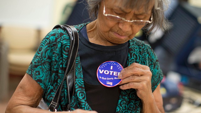 PHOTO: Aida Castillo places a sticker on her blouse indicating that she had voted during the early voting period, Saturday, Oct. 20, 2012, in Las Vegas.