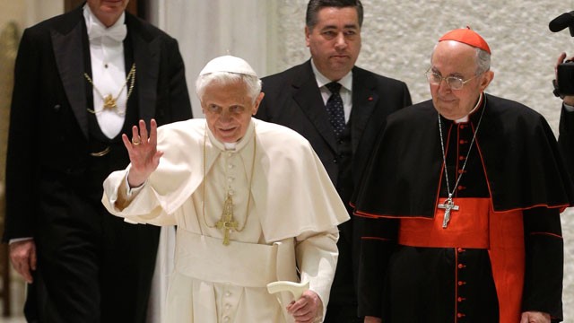 PHOTO: Pope Benedict XVI delivers his blessing as he arrives for an audience the with Roman clergy.