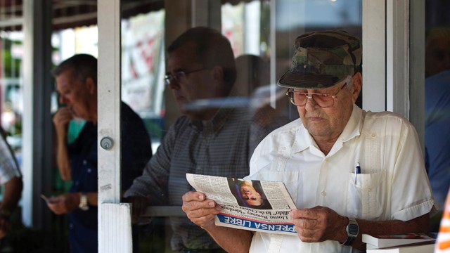 PHOTO:&nbsp;Nino Diaz reads a Spanish language newspaper at a Cuban cafe in Miami's Little Havana section.