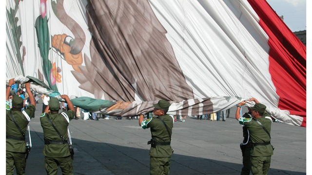 Mexico's flag is wrapped by officials.