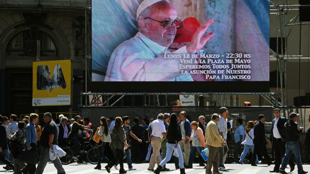 PHOTO: A screen in Buenos Aires, Argentina invites people to gather in the Plaza de Mayo to watch the Pope's inauguration ceremony. Catholics around the world expect different things from the new Pope.