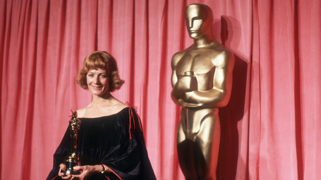 PHOTO: April 1978: British actor Vanessa Redgrave stands in front of a red curtain and a large Oscar statue, smiling and holding the Oscar she won for Best Supporting Actress in director Fred Zinnemann's film, 'Julia,' Los Angeles, California.