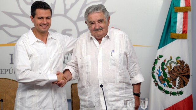 PHOTO: Uruguayan President Jose Mujica shakes hands with Mexican President Enrique Peña Nieto, during a press conference in Montevideo on Monday, Jan. 28. Mujica is known for his austere ways, and has been nicknamed 