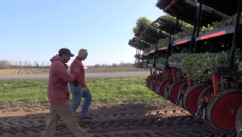 Eric Hansen of Hansen Farms in upstate New York walks through his cabbage field with guest worker Heli Enrique Silva Pelaz.
