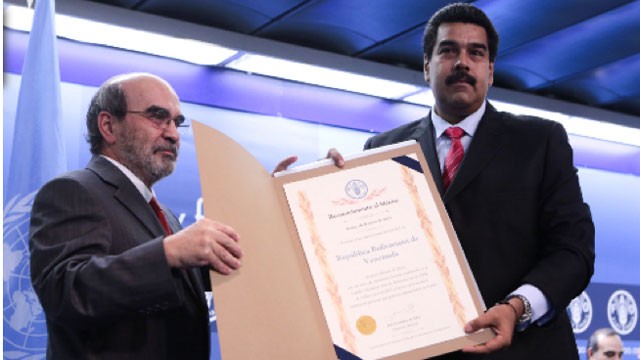PHOTO: Venezuelan President Nicolas Maduro, poses with FAO director Jose Graziano da Silva. On Sunday, The FAO, aawarded Venezuela a special certificate for reducing hunger by half, despite current food shortages in the South American nation.