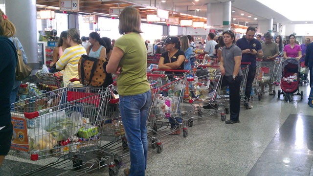 PHOTO: Customers wait in long lines at the Excelsior Gamma supermarket in the neighborhood of Sebucan in Caracas, Venezuela.