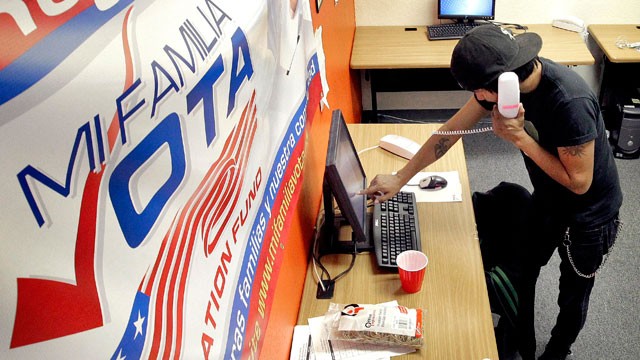 PHOTO: Pedro Yazzie, 27, makes phone calls Tuesday, Nov. 6, 2012 in Phoenix to registered voters from the offices of Mi Familia Vota, a non-partisan effort to increase voter participation among Latinos and others.