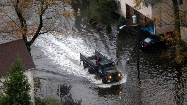 PHOTO:&nbsp;An emergency vehicle drives on a flooded street in Little Ferry, N.J. in the wake of superstorm Sandy on Tuesday, Oct. 30, 2012. Sandy caused multiple fatalities, halted mass transit and cut power to more than 6 million homes and businesses.