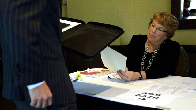 PHOTO: , Patti Maurer of Pompano Beach, Fla., right, registers a job seeker at a job fair held by National Career Fairs, in Fort Lauderdale, Fla.