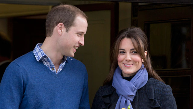 PHOTO: Britain's Prince William stands next to his wife Kate, Duchess of Cambridge as she leaves the King Edward VII hospital in central London.
