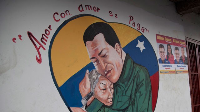 PHOTO:&nbsp;A heart-shaped mural shows an image of Venezuela's President Hugo Chavez hugging a woman in Caracas.