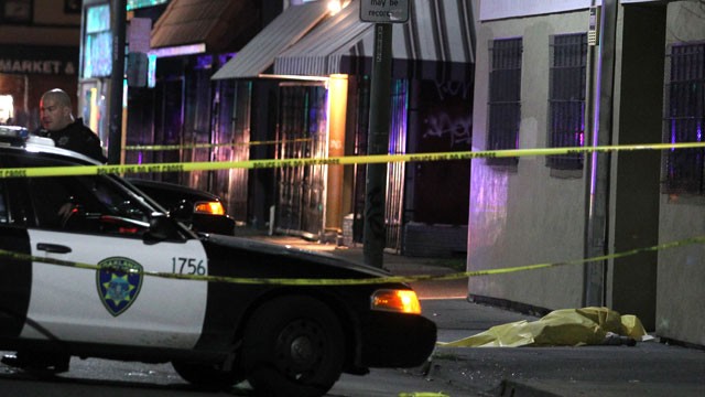 PHOTO:&nbsp;This Dec. 19, 2012 photo shows the body of a woman covered under a yellow tarp after she was killed by an errant bullet on the International Boulevard in Oakland, Calif.