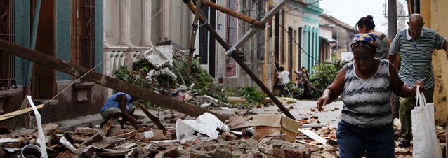 Residents walk through the rubble from homes that were damaged by Hurricane Sandy in Santiago de Cuba, Cuba, Friday Oct. 26, 2012.