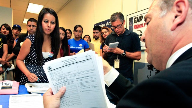 PHOTO: Gaby Perez, left, hands over all her paperwork to get guidance from immigration attorney Jose Penalosa, right, in Phoenix on August 15, 2012, for a new federal program, called Deferred Action, that would help some young undocumented immigrants avoi