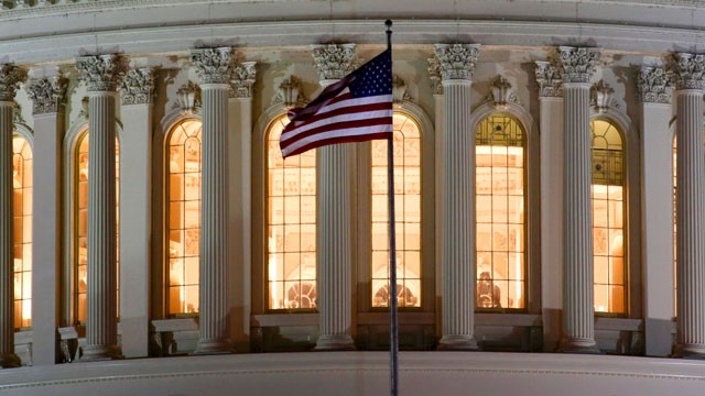 PHOTO: The U.S. flag flies in front of the U.S. Capitol in Washington as Congress works into the late evening Sunday, Dec. 30, 2012 to resolve the stalemate over the