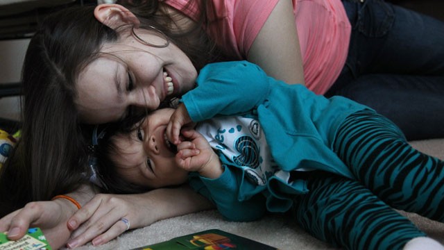 In this Tuesday, March 26, 2013, photo, Adreanna Guiterrez, 18, plays with daughter Alicia Elena Garcia in their foster home in Houston. Adreanna is one of many teens benefiting from a Child Protective Services drive to help high school seniors in the foster care system that might not be able to afford items for their prom event their senior year. (Mayra Beltran/Houston Chronicle/AP Photo)