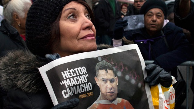 PHOTO: Magaly Diaz, of New York, watches as a procession carries Hector