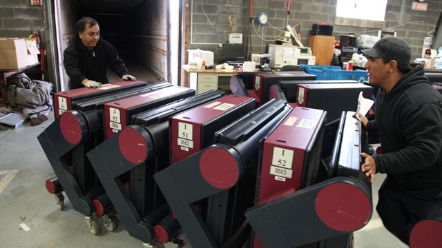  Walter Huancaya and his son, Jose, load up voting machines to be delivered to Bergenfield and Haworth Friday morning Nov. 2, 2012. Bergen County voting booths are leaving the distribution center to towns for Election Day.