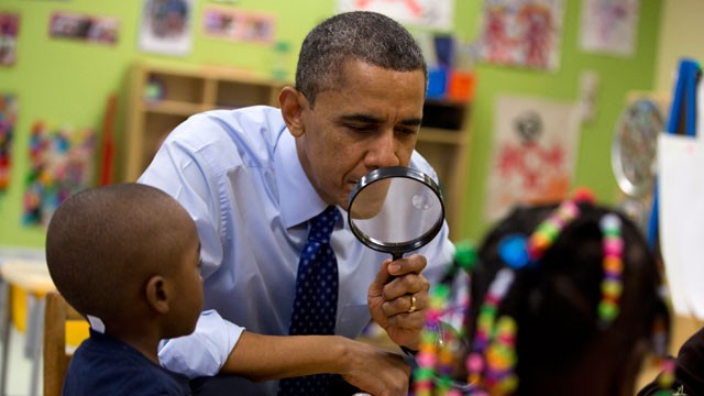 PHOTO: President Barack Obama looks through a magnifying glass during a learning game at a pre-kindergarten classroom at College Heights Early Childhood Learning Center in Decatur, Ga., Thursday, Feb. 14, 2013.