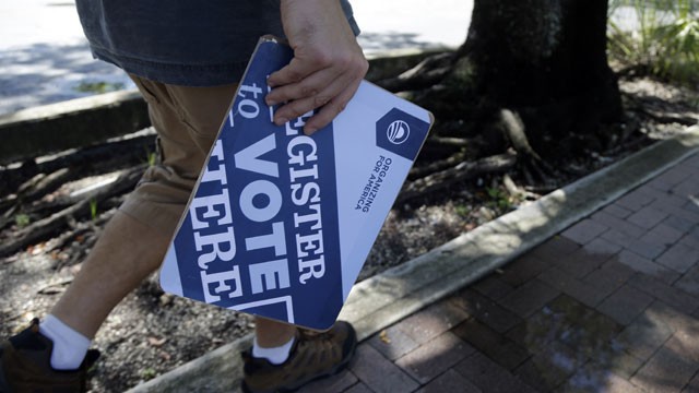 PHOTO:&nbsp;Matt Sagorski, a volunteer for the campaign of President Barack Obama, walks in a neighborhood with voter registration forms, Monday, Oct. 8, 2012 in Miami.