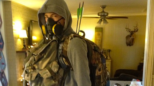 PHOTO: A young man dressed in survivalist gear, "bug-out bag" and all.