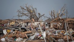 PHOTO: MOORE, OK - MAY 20: People assess the damage after a powerful tornado ripped through the area on May 20, 2013 in Moore, Oklahoma.