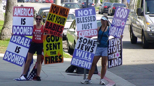 PHOTO: Members of the Westboro Baptist Church hold signs on a street corner.