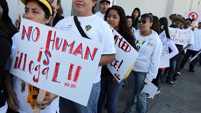 PHOTO: OAKLAND, CA - APRIL 30: People with the group 'Youth United For Justice' hold signs in protest of Arizona's immigration law.