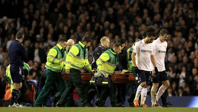 Dr Andrew Deaner (right) walks off the pitch as Fabrice Muamba of Bolton Wanderers is taken off on a stretcher, still unconscious after receiving CPR treatment on the pitch.