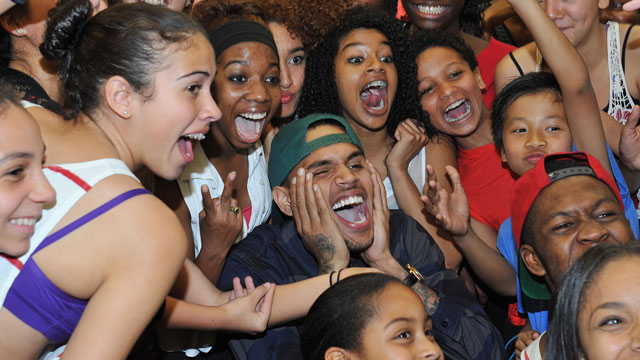 PHOTO: Chris Brown poses with excited fans during a visit to the Debbie Allen Dance Academy.