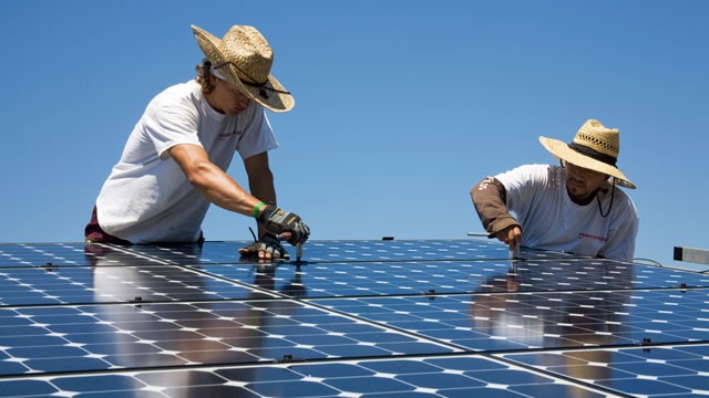 PHOTO: Green workers install a residential grid-tied solar array on a hillside in Malibu, California, USA.
