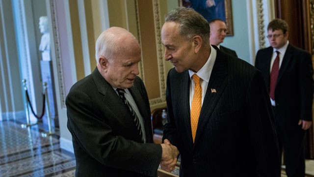 PHOTO: Senator John McCain (R-AZ) (L) and Senator Charles E. Schumer (D-NY), two authors of the immigration bill, shake hands after a test vote on Capitol Hill June 27, 2013 in Washington, D.C.