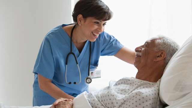 PHOTO: A Latina nurse assists a patient.