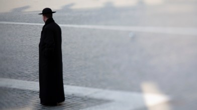PHOTO: A priest walks through St. Peter's Square in Vatican City.
