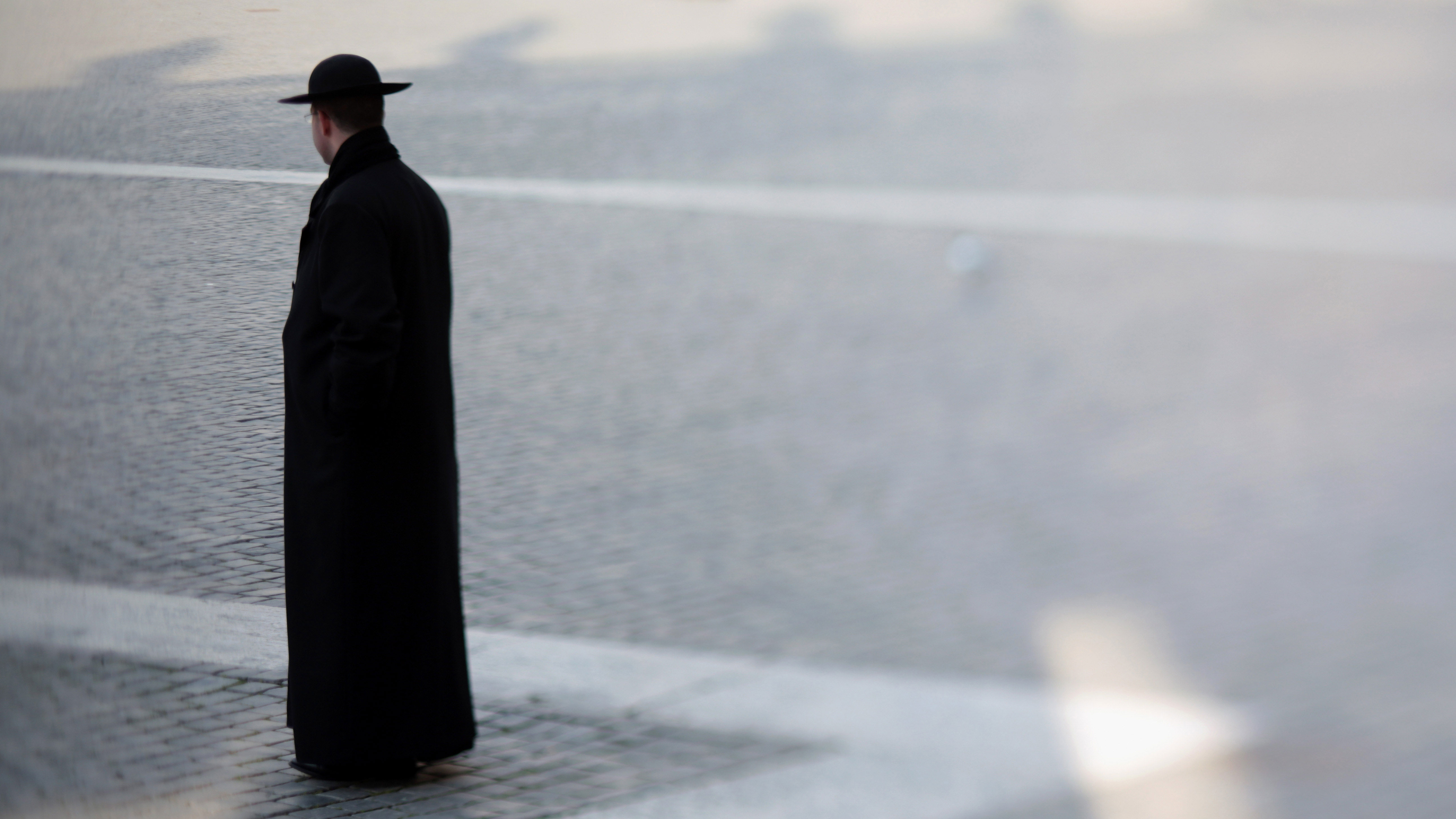PHOTO: A priest walks through St. Peter's Square in Vatican City.