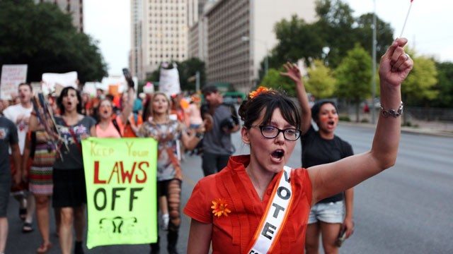 PHOTO: Pro-choice protesters march down Congress Avenue and back to the Texas state capitol as pro-life supporters and pro-choice protesters rally at the Texas state capitol on July 8, 2013 in Austin Texas.
