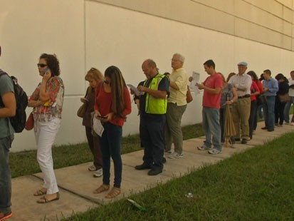 Long lines like at this Miami polling place, have turned some early voters away.