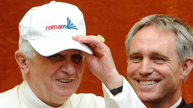 PHOTO:Pope Benedict XVI wears a cap offered by Germany's Paul Biedermann, gold medallist in the men's 200m freestyle.