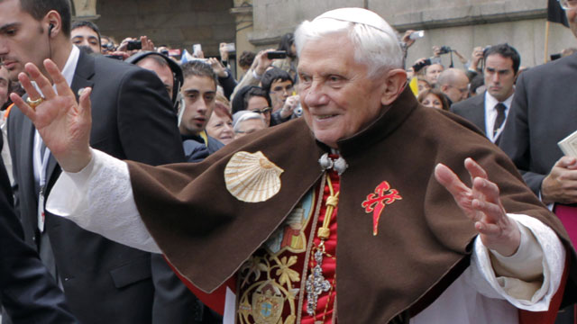PHOTO: Pope Benedict XVI waves to faithful as he wears a pilgrim cape with a scallop shell and a Santiago cross embroidered on it during his visit in Santiago de Compostela, on November 6, 2010.