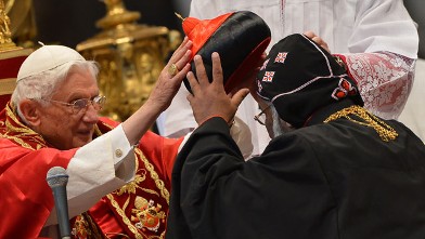 PHOTO: India's Baselios Cleemis Thottunkal receives his hat as Pope Benedict XVI (L) appoints him as a cardinal during a ceremony on November 24, 2012 at St Peter's basilica at the Vatican.