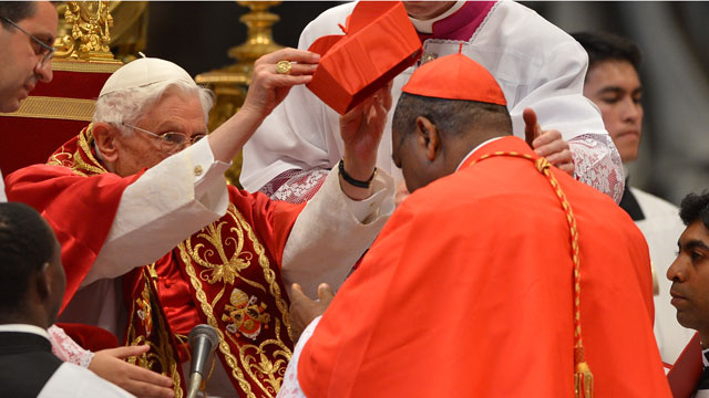 PHOTO: Nigeria's John Onaiyekan receives his biretta hat as Pope Benedict XVI (L) appoints him as a cardinal during a ceremony on November 24, 2012 at St Peter's basilica at the Vatican.