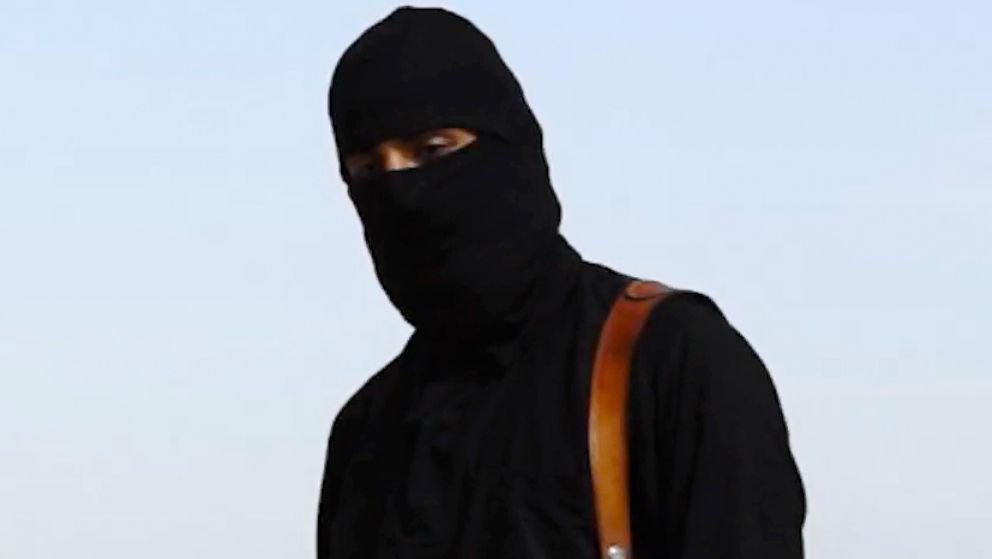 PHOTO: A masked man, who describes himself as a member of ISIS, appears to behead Western hostages in online videos.