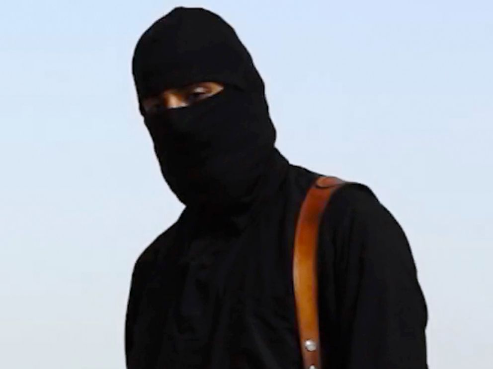 PHOTO: A masked man, who describes himself as a member of ISIS, appears to behead Western hostages in online videos.